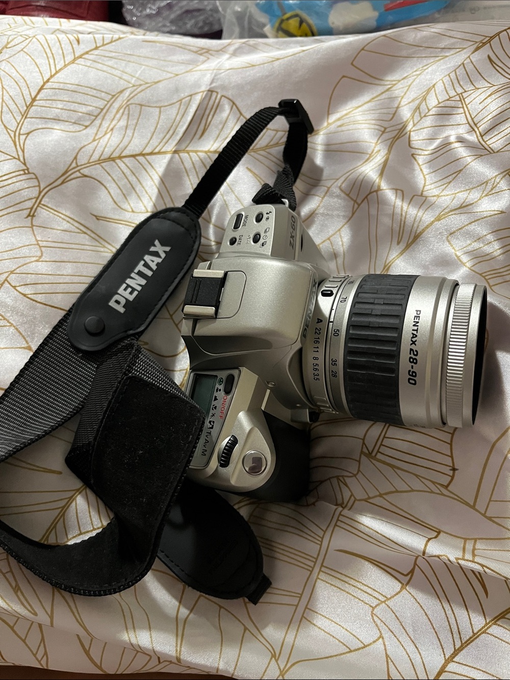 Pentax Silver and Black DSLR with 28-90mm Zoom Lens and Branded Strap